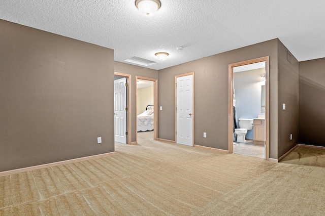 15440 Eminence Ave N Unit 2, Hugo, MN 55038 - unfurnished bedroom with a textured ceiling, carpet, ensuite bathroom, and baseboards