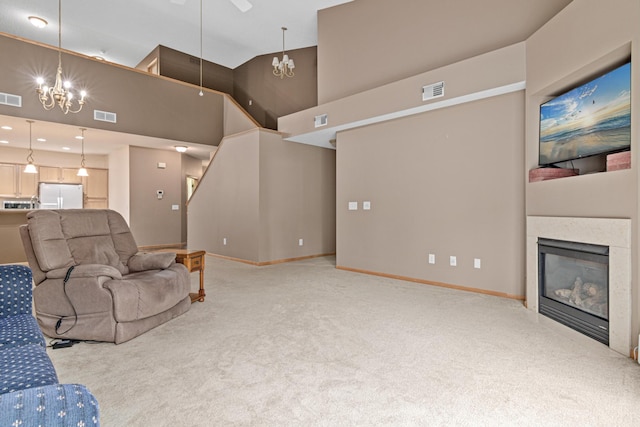 15440 Eminence Ave N Unit 2, Hugo, MN 55038 - living room with carpet flooring, a glass covered fireplace, high vaulted ceiling, baseboards, and ceiling fan