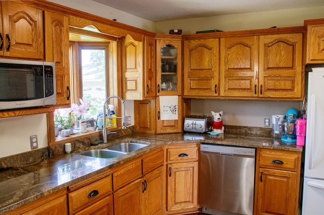 44818 215th Ave, Staples Twp, MN 56479 - kitchen with appliances with stainless steel finishes, brown cabinetry, and glass insert cabinets