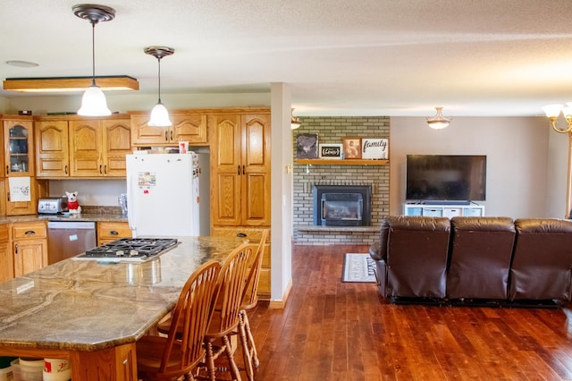 44818 215th Ave, Staples Twp, MN 56479 - kitchen featuring stainless steel appliances, stone countertops, dark wood finished floors, a brick fireplace, and open floor plan
