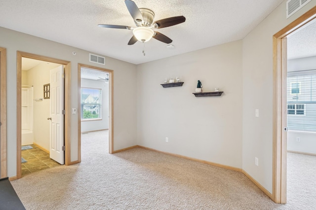 1964 Commonwealth Blvd Unit 5, Chanhassen, MN 55317 - spare room with light colored carpet, ceiling fan, plenty of natural light, and a textured ceiling