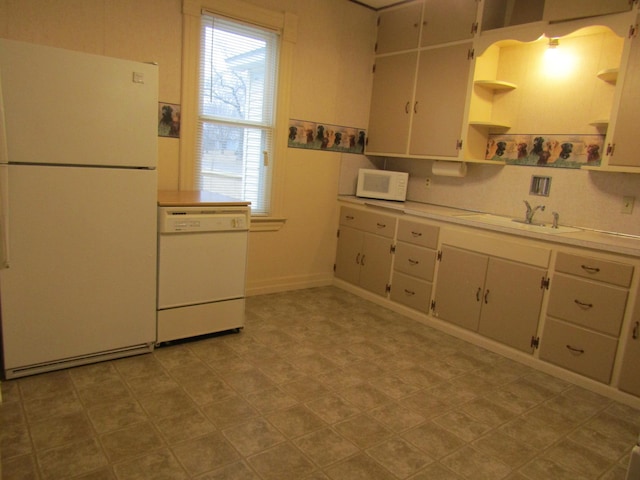 421 8th Ave, Madison, MN 56256 - kitchen featuring white appliances, a sink, open shelves, light countertops, and baseboards