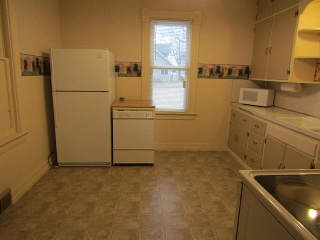 421 8th Ave, Madison, MN 56256 - kitchen featuring white appliances, open shelves, a sink, and white cabinets
