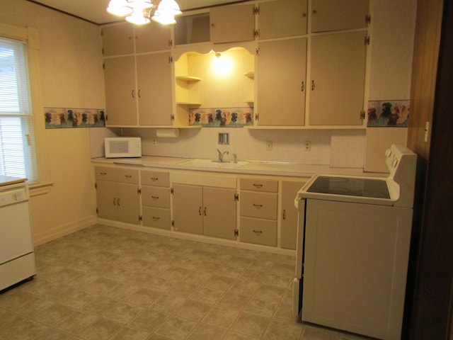 421 8th Ave, Madison, MN 56256 - kitchen with white appliances, open shelves, light countertops, washer / dryer, and a sink