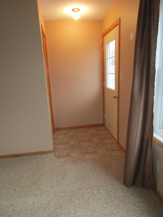 421 8th Ave, Madison, MN 56256 - entryway featuring baseboards and light colored carpet