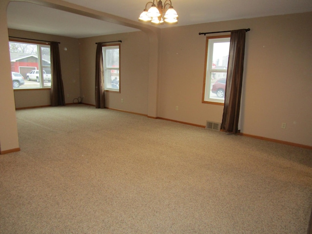 421 8th Ave, Madison, MN 56256 - carpeted spare room with a chandelier and baseboards