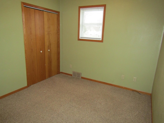 421 8th Ave, Madison, MN 56256 - unfurnished bedroom with a closet, carpet flooring, and baseboards
