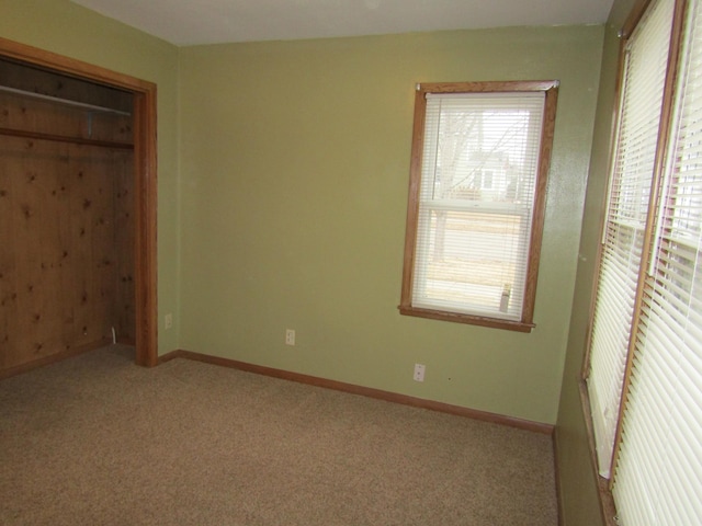 421 8th Ave, Madison, MN 56256 - unfurnished bedroom featuring baseboards and carpet flooring