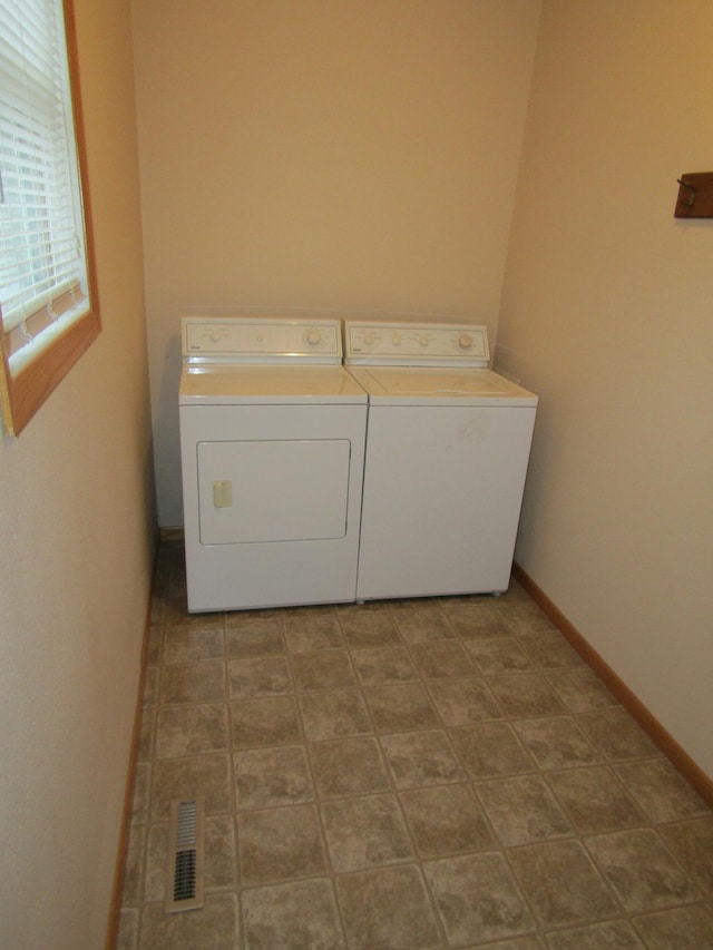 421 8th Ave, Madison, MN 56256 - washroom featuring washing machine and clothes dryer and baseboards