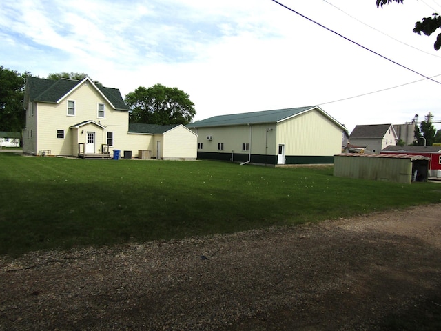 421 8th Ave, Madison, MN 56256 - view of grassy yard featuring cooling unit and an outdoor structure