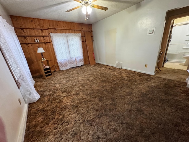 1020 Autumn St, Albert Lea, MN 56007 - unfurnished bedroom with carpet flooring, a textured ceiling, wooden walls, connected bathroom, and baseboards