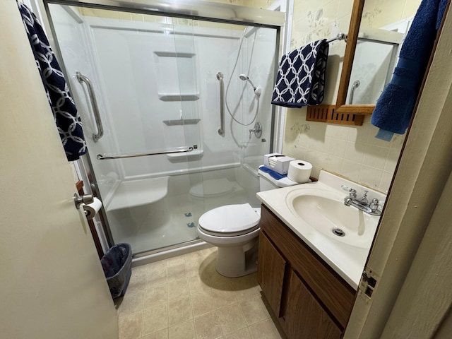 1020 Autumn St, Albert Lea, MN 56007 - bathroom with a stall shower, tasteful backsplash, toilet, vanity, and tile patterned flooring