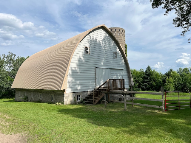 355 20th St SW, Benson, MN 56215 - view of home's exterior with a gambrel roof and a garage