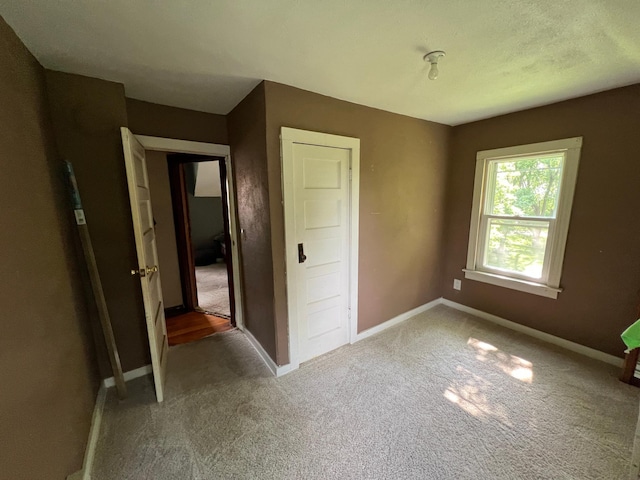 355 20th St SW, Benson, MN 56215 - unfurnished bedroom featuring carpet and baseboards