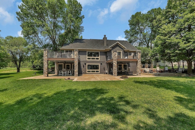 27806 Sundance Ln, Cold Spring, MN 56320 - rear view of property with a patio area, a balcony, a yard, a chimney, and stone siding