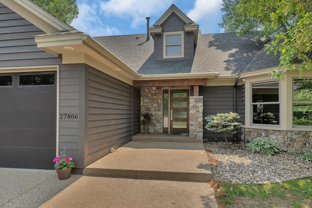 27806 Sundance Ln, Cold Spring, MN 56320 - entrance to property featuring stone siding, a shingled roof, and an attached garage
