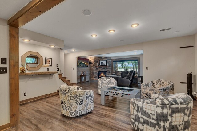 27806 Sundance Ln, Cold Spring, MN 56320 - living room featuring wood finished floors, a fireplace, stairs, and recessed lighting