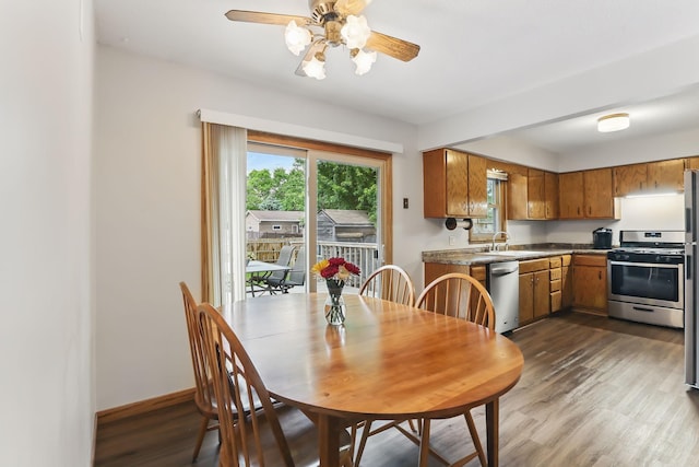 1202 Lyn Way, Hastings, MN 55033 - dining room featuring dark wood-type flooring, ceiling fan, and baseboards