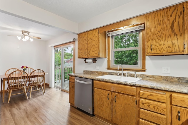 1202 Lyn Way, Hastings, MN 55033 - kitchen featuring stainless steel dishwasher, a sink, light wood-style flooring, and plenty of natural light
