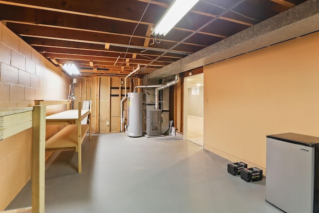1202 Lyn Way, Hastings, MN 55033 - unfinished below grade area featuring stainless steel refrigerator, gas water heater, heating unit, and concrete block wall