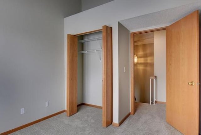15610 24th Ave N Unit F, Plymouth, MN 55447 - unfurnished bedroom featuring light colored carpet, a closet, and baseboards