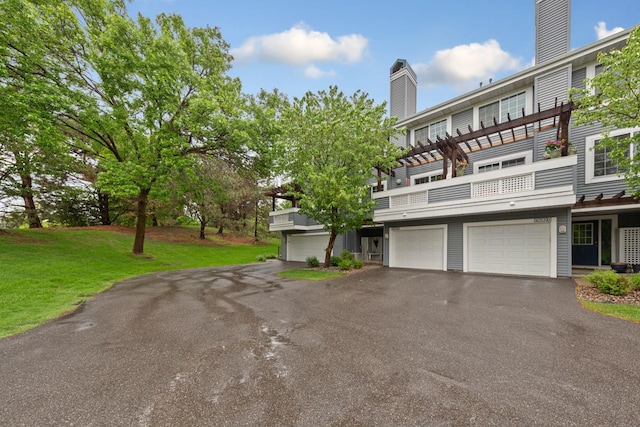 15610 24th Ave N Unit F, Plymouth, MN 55447 - view of front facade featuring an attached garage, a front yard, asphalt driveway, and a balcony