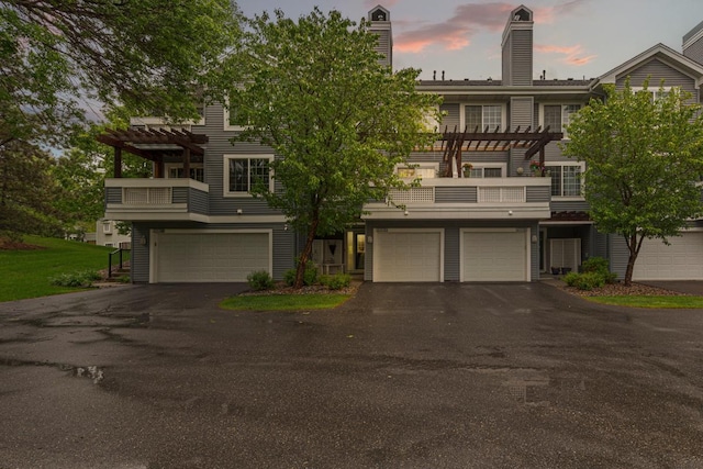 15610 24th Ave N Unit F, Plymouth, MN 55447 - view of property featuring a pergola, a balcony, and driveway