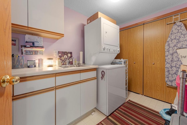 15610 24th Ave N Unit F, Plymouth, MN 55447 - laundry area featuring stacked washer / dryer, cabinet space, and a textured ceiling