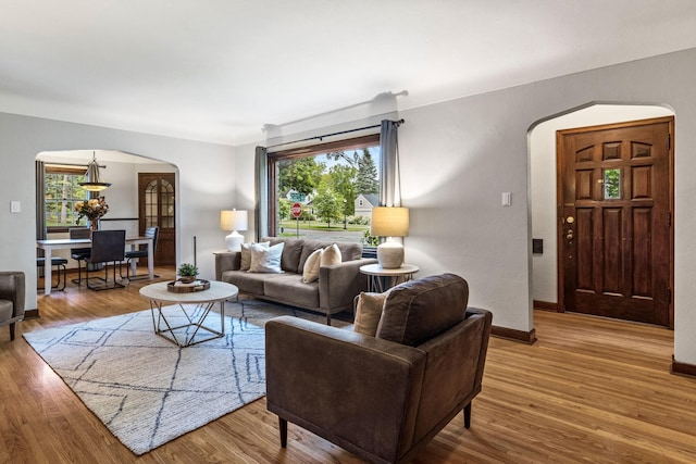 591 Wheelock Pkwy W, Saint Paul, MN 55117 - living area featuring arched walkways, wood finished floors, and plenty of natural light
