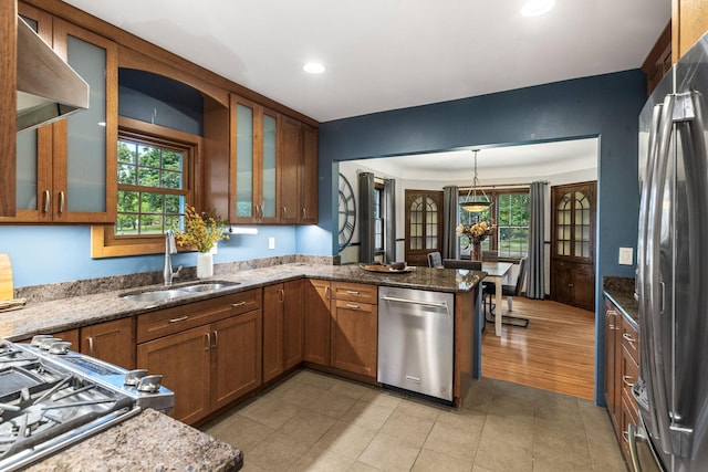 591 Wheelock Pkwy W, Saint Paul, MN 55117 - kitchen with stainless steel appliances, a sink, a peninsula, stone counters, and recessed lighting