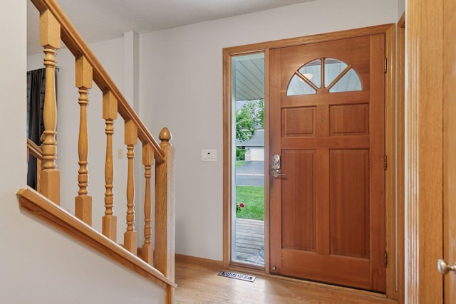 1502 Rocky Ln, Eagan, MN 55122 - entryway with wood finished floors, stairway, and baseboards