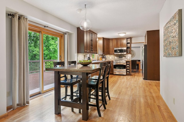 1502 Rocky Ln, Eagan, MN 55122 - dining area with light wood-style floors