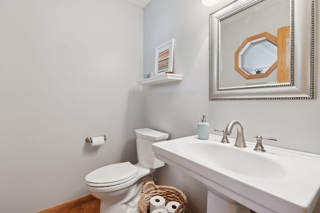1502 Rocky Ln, Eagan, MN 55122 - bathroom with toilet, wood finished floors, and baseboards