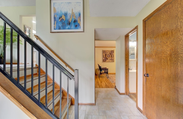 3021 Crescent Ln NW, Rochester, MN 55901 - staircase with baseboards and stone finish floors