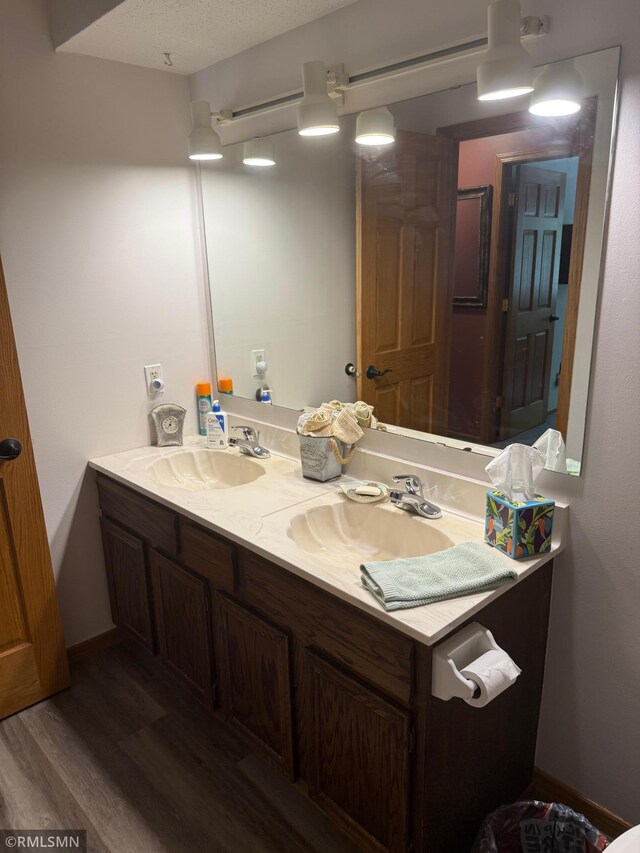 6800 Buckingham Ct, Woodbury, MN 55125 - bathroom with double vanity and wood finished floors