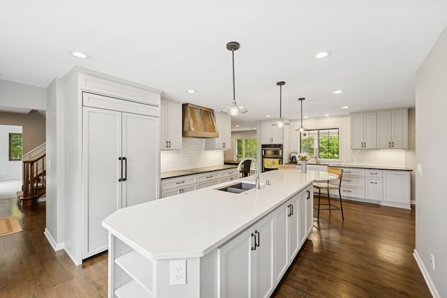200 Marie Ave W, West Saint Paul, MN 55118 - kitchen with custom exhaust hood, decorative backsplash, dark wood-style floors, recessed lighting, and a large island with sink