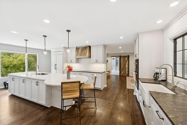 200 Marie Ave W, West Saint Paul, MN 55118 - kitchen featuring premium range hood, a barn door, dark wood finished floors, tasteful backsplash, and recessed lighting