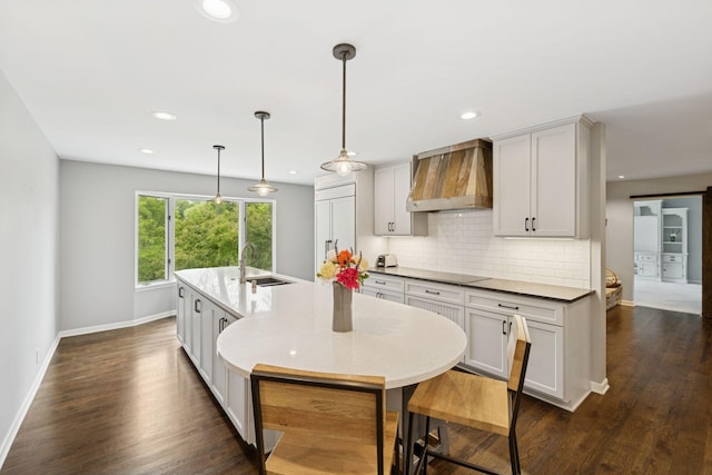 200 Marie Ave W, West Saint Paul, MN 55118 - kitchen with custom exhaust hood, decorative backsplash, recessed lighting, a center island with sink, and dark wood finished floors