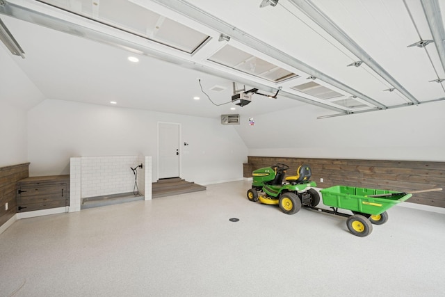 200 Marie Ave W, West Saint Paul, MN 55118 - garage featuring a garage door opener, wood walls, and recessed lighting