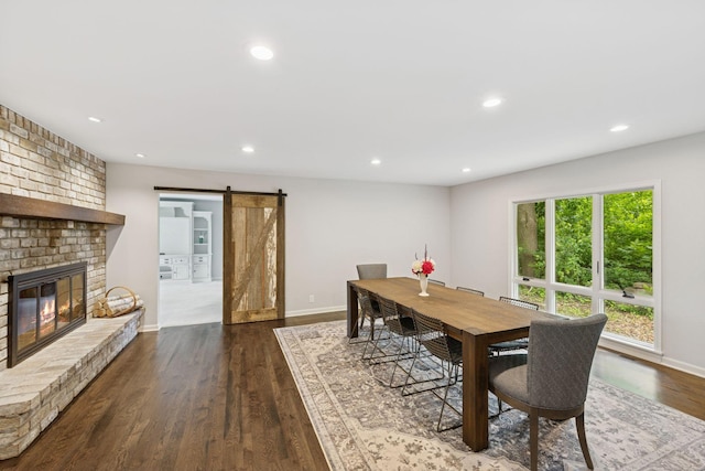 200 Marie Ave W, West Saint Paul, MN 55118 - dining space featuring a barn door, wood finished floors, recessed lighting, and a fireplace