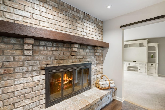 200 Marie Ave W, West Saint Paul, MN 55118 - detailed view of a fireplace, a barn door, and wood finished floors