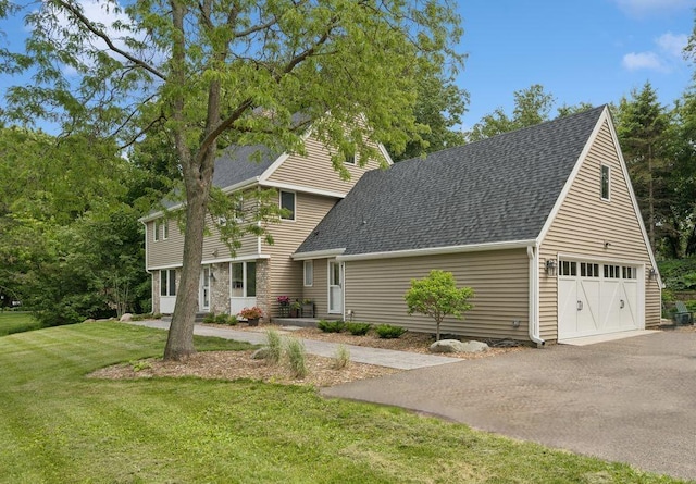 200 Marie Ave W, West Saint Paul, MN 55118 - view of front of house with roof with shingles, asphalt driveway, and a front lawn