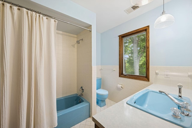 200 Marie Ave W, West Saint Paul, MN 55118 - full bathroom with vanity, shower / tub combo with curtain, tile walls, wainscoting, and tile patterned floors
