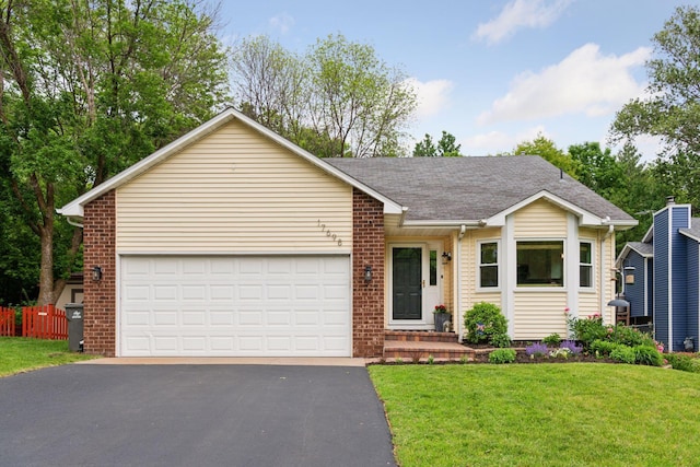17698 Shore Ln W, Eden Prairie, MN 55346 - single story home with asphalt driveway, brick siding, an attached garage, a front yard, and roof with shingles