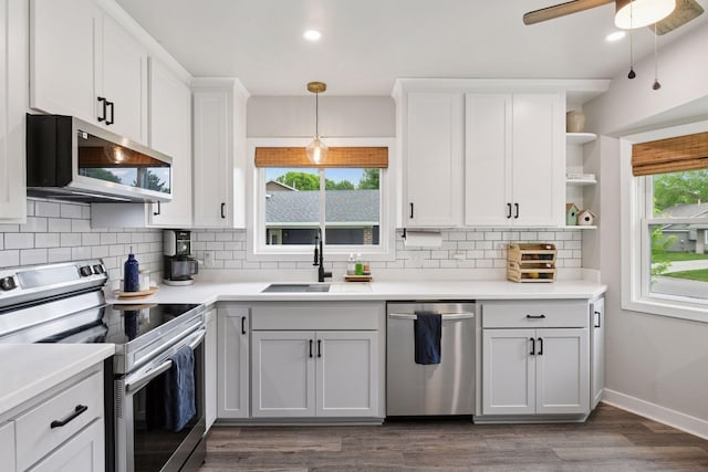 17698 Shore Ln W, Eden Prairie, MN 55346 - kitchen with stainless steel appliances, a sink, open shelves, backsplash, and hanging light fixtures