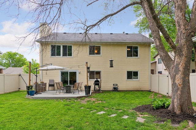 17698 Shore Ln W, Eden Prairie, MN 55346 - back of property featuring a patio area and a chimney
