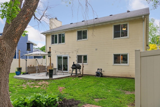 17698 Shore Ln W, Eden Prairie, MN 55346 - back of house with a chimney and a patio