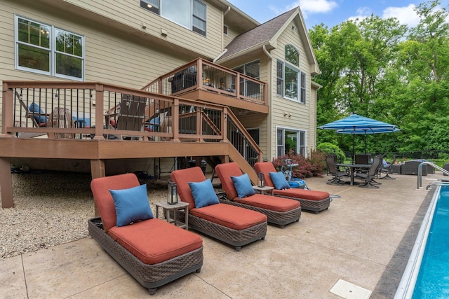 6539 Orchard Ridge Trl, Woodbury, MN 55129 - rear view of property with stairs, an outdoor pool, a patio, and a wooden deck