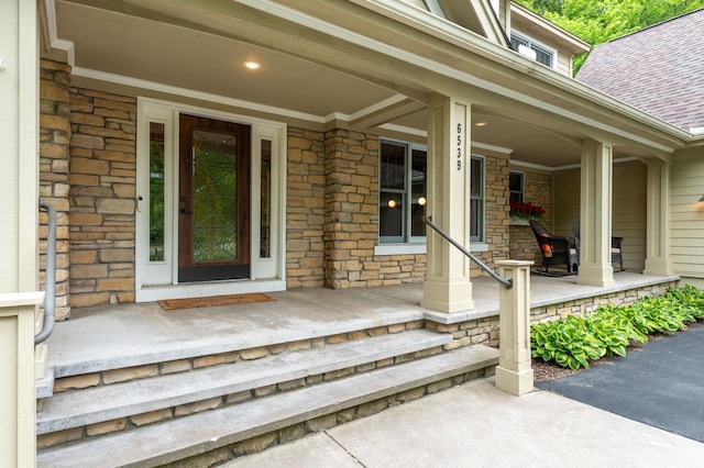 6539 Orchard Ridge Trl, Woodbury, MN 55129 - property entrance featuring a porch, a shingled roof, and stone siding