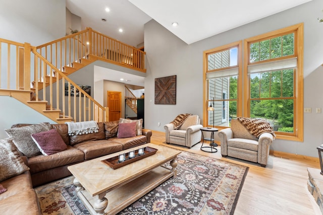 6539 Orchard Ridge Trl, Woodbury, MN 55129 - living area with wood finished floors, stairway, recessed lighting, a high ceiling, and baseboards